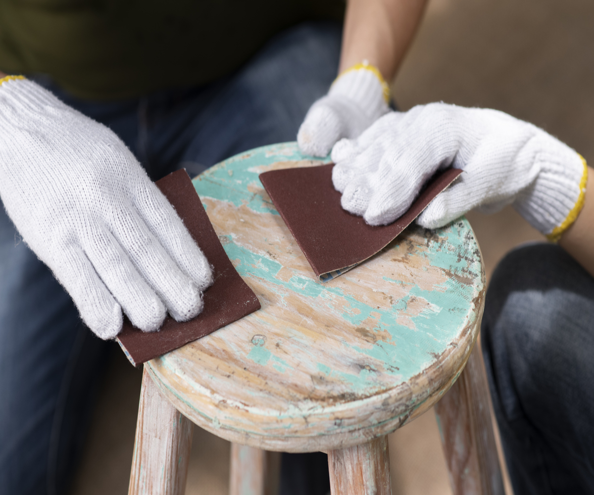 high-angle-hands-using-sandpaper